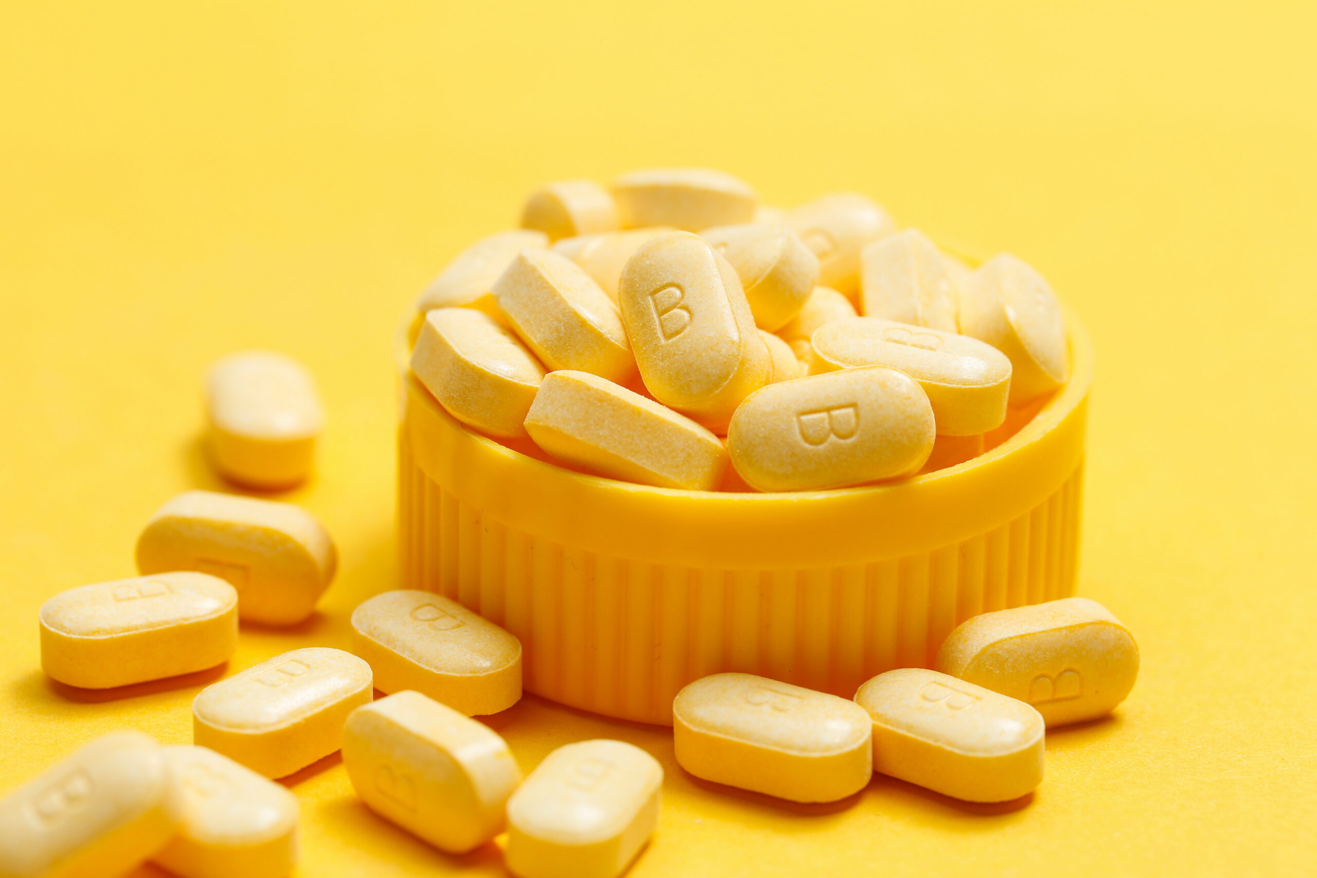 vitamin B tablets contains of Affro B on yellow background